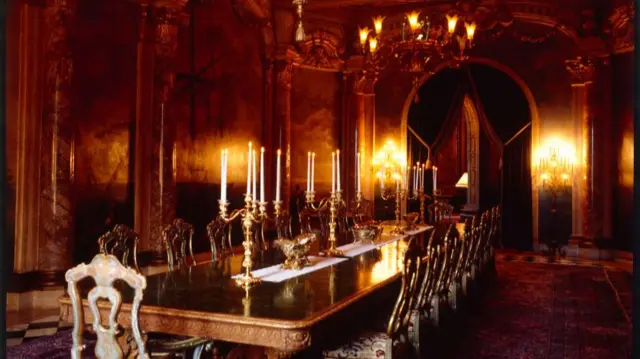 the grand dining room, complete with gold candelabras and chandeliers