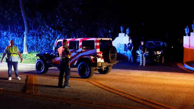 Police officers and Secret service members stand guard outside former US President Donald Trump's Mar-a-Lago home