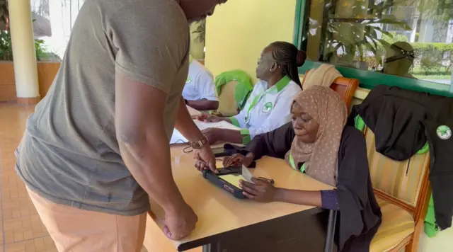 A voter using a verification kit at the Kenyan embassy in Dar es Salaa