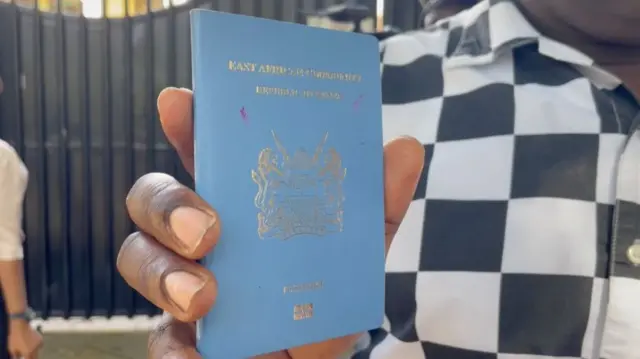 A person holding a passport at the Kenya embassy in Dar es Salaam