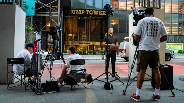 Members of the media gather outside Trump Tower