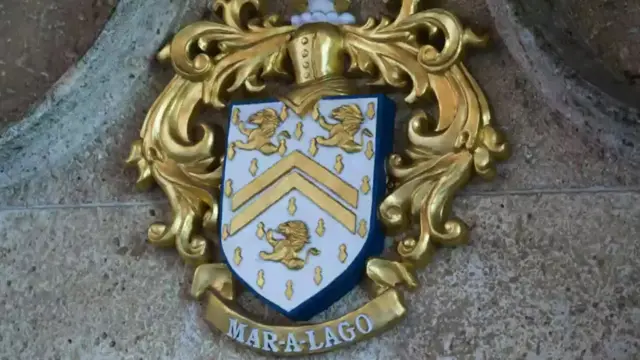 A gold Mar-a-Lago coat of arms outside the property