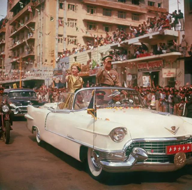 Queen Elizabeth II is driven through the streets of Karachi during the second phase of her tour of Pakistan