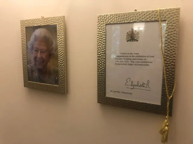 A Platinum Wedding anniversary card signed by the Queen.