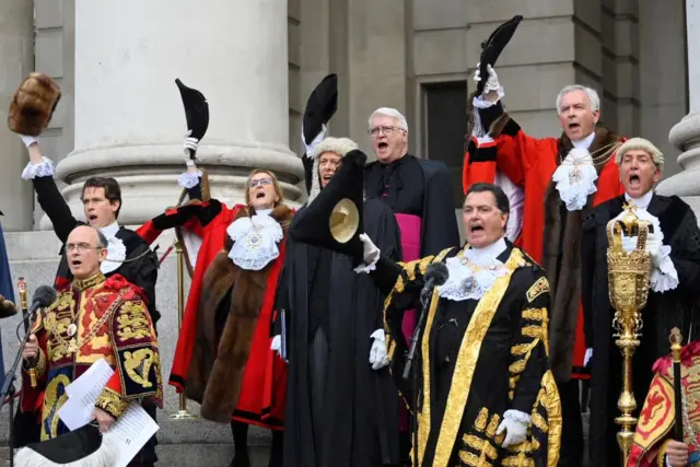 Officials and elected members of the City of London Corporation, doff their hats during the reading of the Proclamation of Accession of King Charles III at the Royal Exchange in the City of London