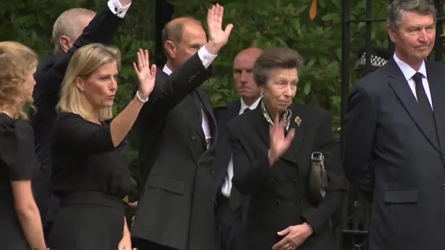 Family members including Princess Anne and Prince Edward wave at the gates