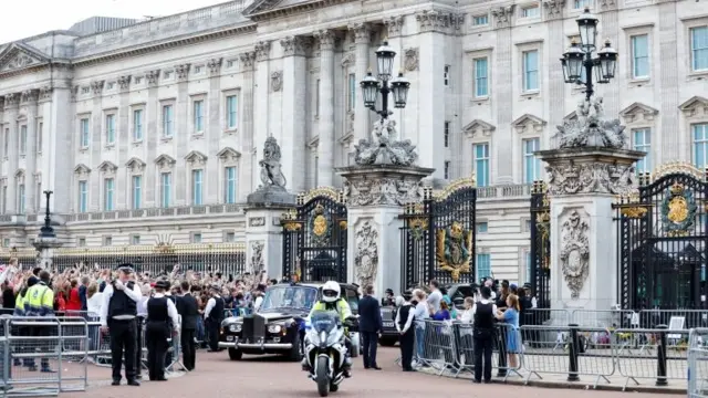 King Charles in a car leaving Buckingham Palace