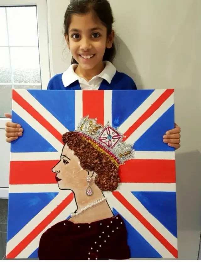 11-year-old Anya Patel holding her portrait of the Queen