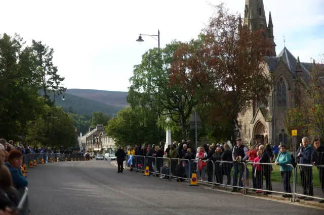 People wait for the procession