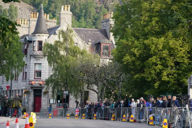 People line up in Balmoral to view the procession of the coffin