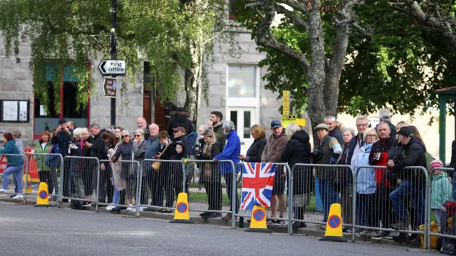 People line the street waiting for the funeral cortege