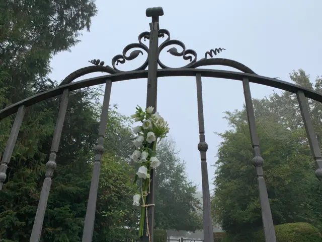 White flowers left on the gates of King Charles III's country home