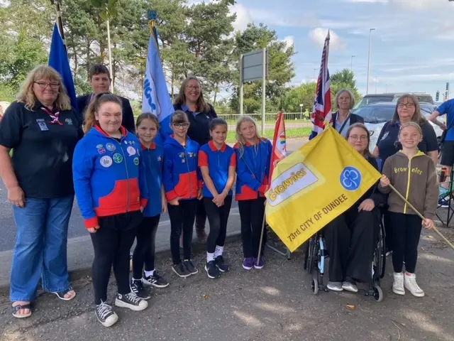 Brownies and Girlguides stand along the route