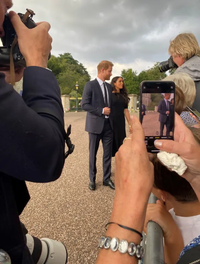 Harry and Meghan spoke to well-wishers waiting patiently at the barriers