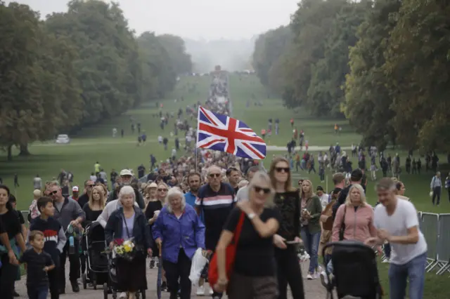 Crowds of people walk along the Long Walk in Windsor