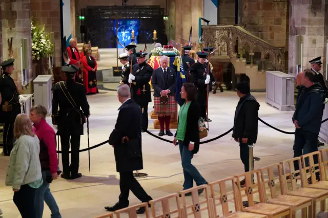 The Queen's children stand beside their mother's coffin as members of the public walk by