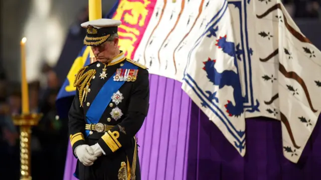 Charles stands vigil by his grandmother, the Queen Mother's, coffin in 2002