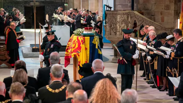 the congregation and choir singing hymns at the service at St Giles' Cathedral on Monday