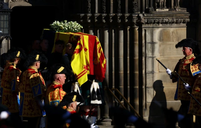 Pallbearers carry the coffin of Queen Elizabeth II