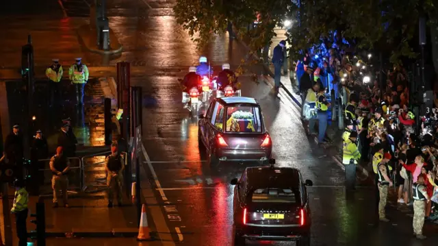 The Queen's motorcade travels to Buckingham Palace