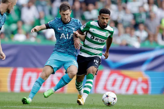 Marcus Edwards and Ben Davies battle for the ball