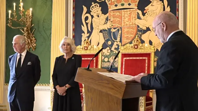 King Charles III and the Queen Consort listen to speaker of the Stormont Assembly Alex Maskey