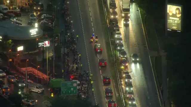 People line A40 to see Queen's coffin pass