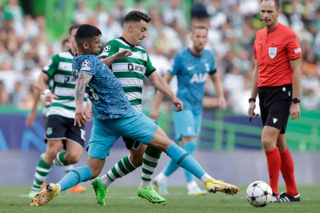 Cristian Romero and Pedro Goncalves battle for the ball