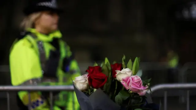 A police officer near flowers