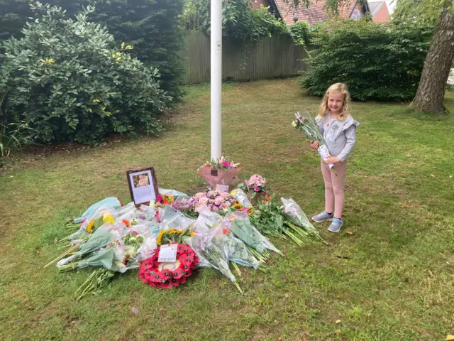 Girl laying flowers