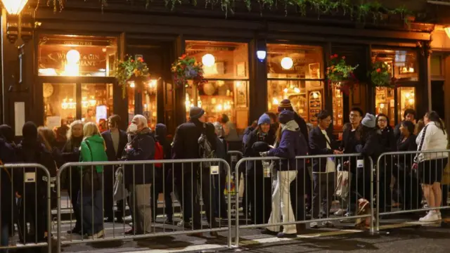 The crowd outside a pub