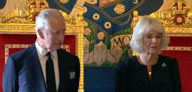 King Charles III and the Queen Consort listen to Alex Maskey's speech