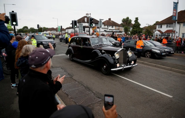 King Charles III and Queen Consort drive away from RAF Northolt after arriving from Belfast