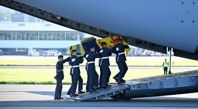 The Queen's coffin is carried into the RAF C-17 transporter