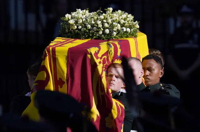 Pallbearers carry the coffin of Queen Elizabeth II to a hearse