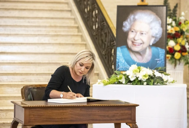 Sinn Fein Vice-President Michelle O'Neill signs a book of condolence to Queen Elizabeth II in Stormont