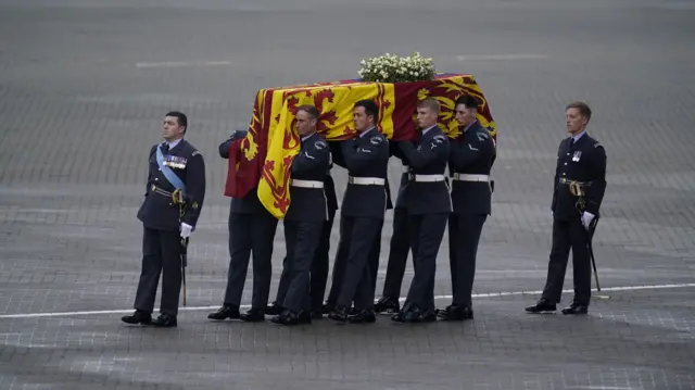 The coffin of Queen Elizabeth II is carried to the waiting hearse at RAF Northolt