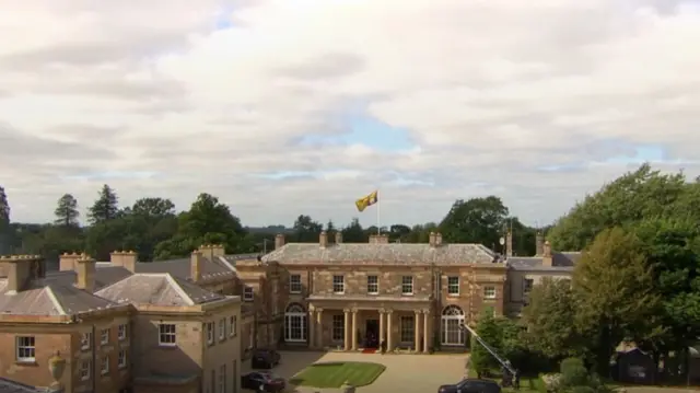 The Royal Standard flies from the flagpole of Hillsborough Castle to mark King Charles III's presence