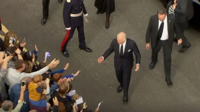 King Charles III walks towards crowds outside Hillsborough Castle