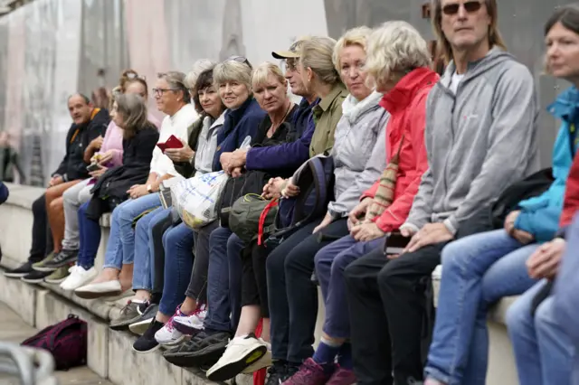 People sitting on a wall in Whitehall