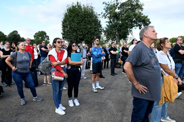 Mourners watch the procession of the coffin of Queen Elizabeth II to Westminster Hall, at the Hyde Park screening site