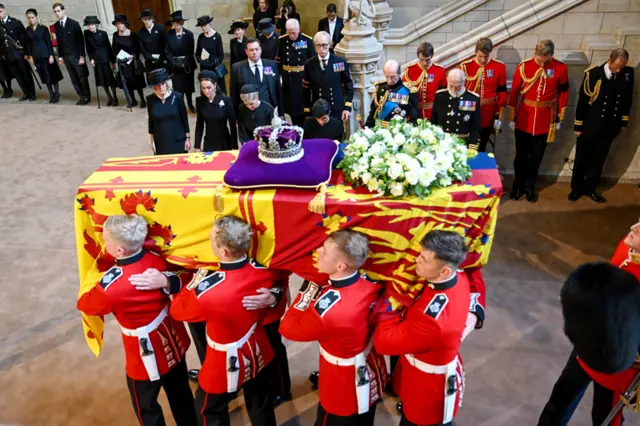 Camilla Queen Consort, Catherine Princess of Wales, Sophie Countess of Wessex and Meghan Duchess of Sussex curtsy  as The coffin of Queen Elizabeth II is brought into Westminster Hall. Queen Elizabeth II's coffin procession from Buckingham Palace to Westminster Hall, London, UK - 14 Sep 2022