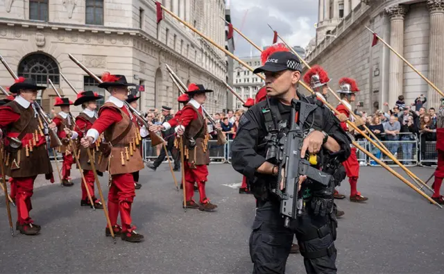 The Company of Pikemen and Musketeers march past armed police and the Bank of England, London, 9 September 2022