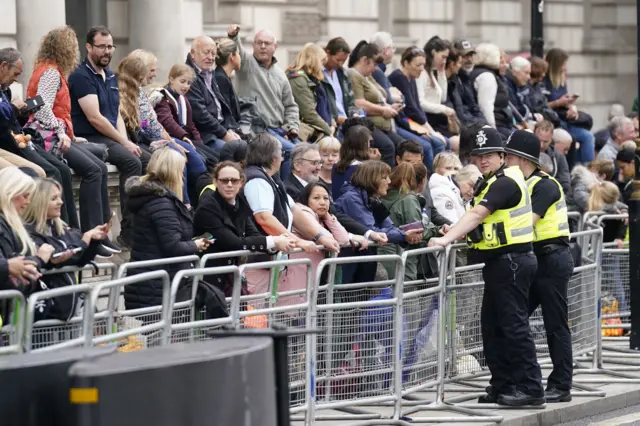 Crowds behind barriers