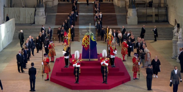 Members of the public queue alongside Queen Elizabeth II's coffin in Westminster Hall