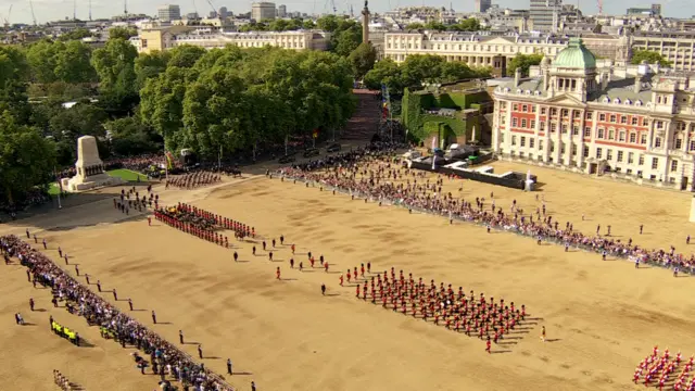 High-angle shot of the Queen's procession crossing Horse Guards Parade in Westminster