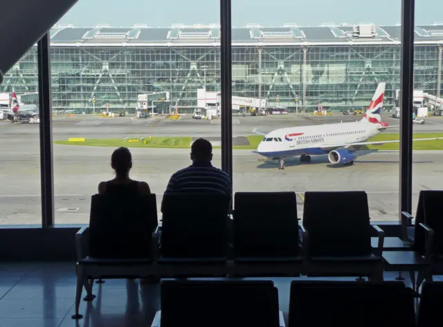 Passengers wait at Heathrow Airport