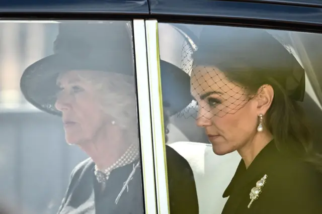 Camilla, Queen Consort (L) and Britain's Catherine, Princess of Wales are driven behind the coffin of Queen Elizabeth II,