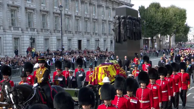 The Queen's procession passes the Cenotaph