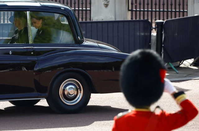 Soldier salutes the queen consort and princess of wales